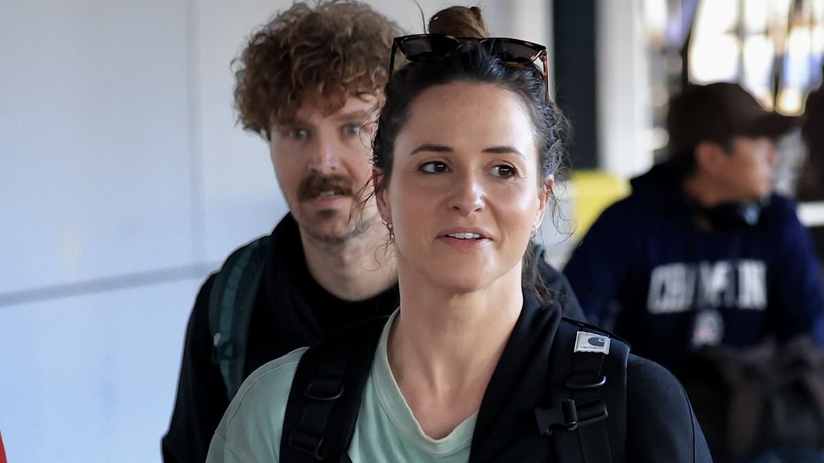 Raygun is all smiles as she FINALLY returns to Australia following her viral Olympics breakdancing disaster that has made her a global superstar