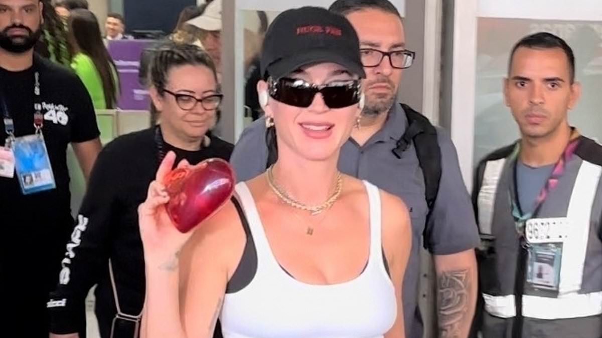 Katy Perry receives gifts from adoring fans who greeted her at the airport in Rio de Janeiro as she arrived ahead of her headline Rock in Rio performance