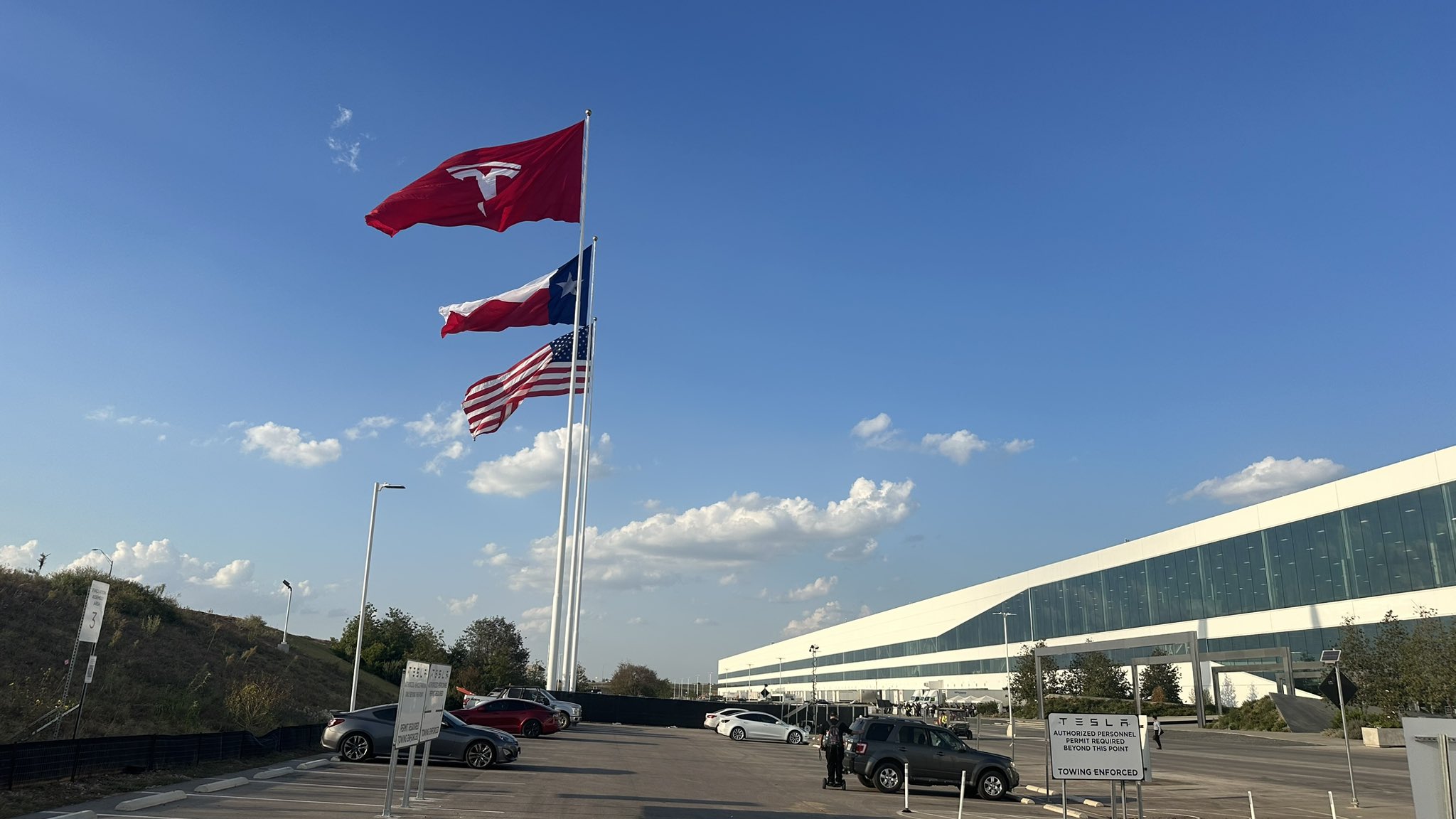 Tesla Giga Texas stands proud with its trifecta of giga flags