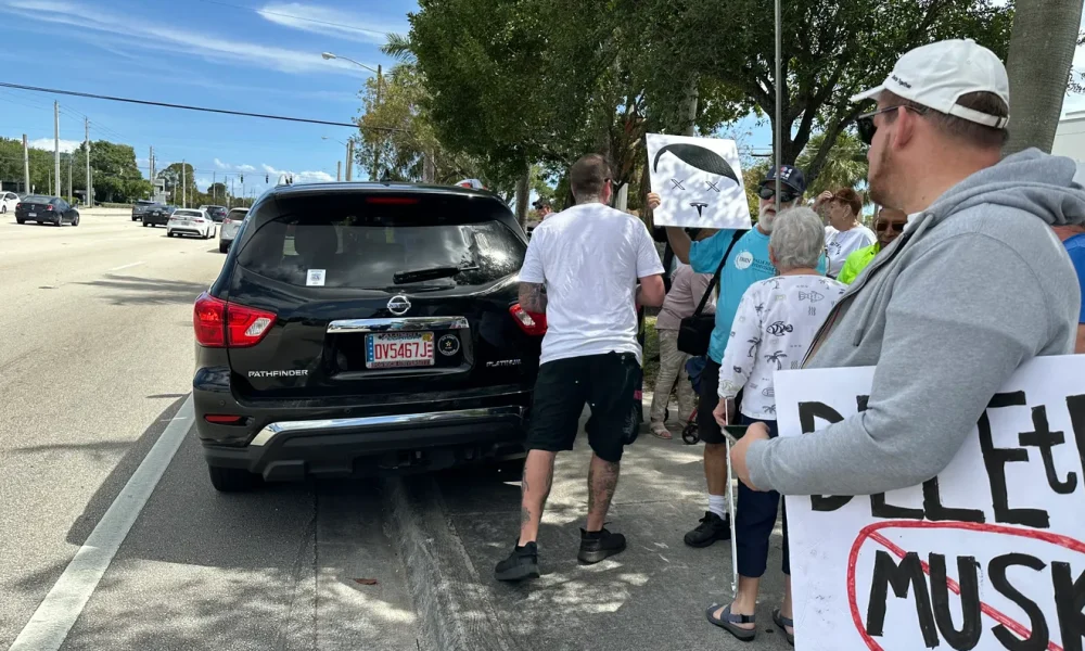 Florida man charged after trying to hit Tesla protestors with car