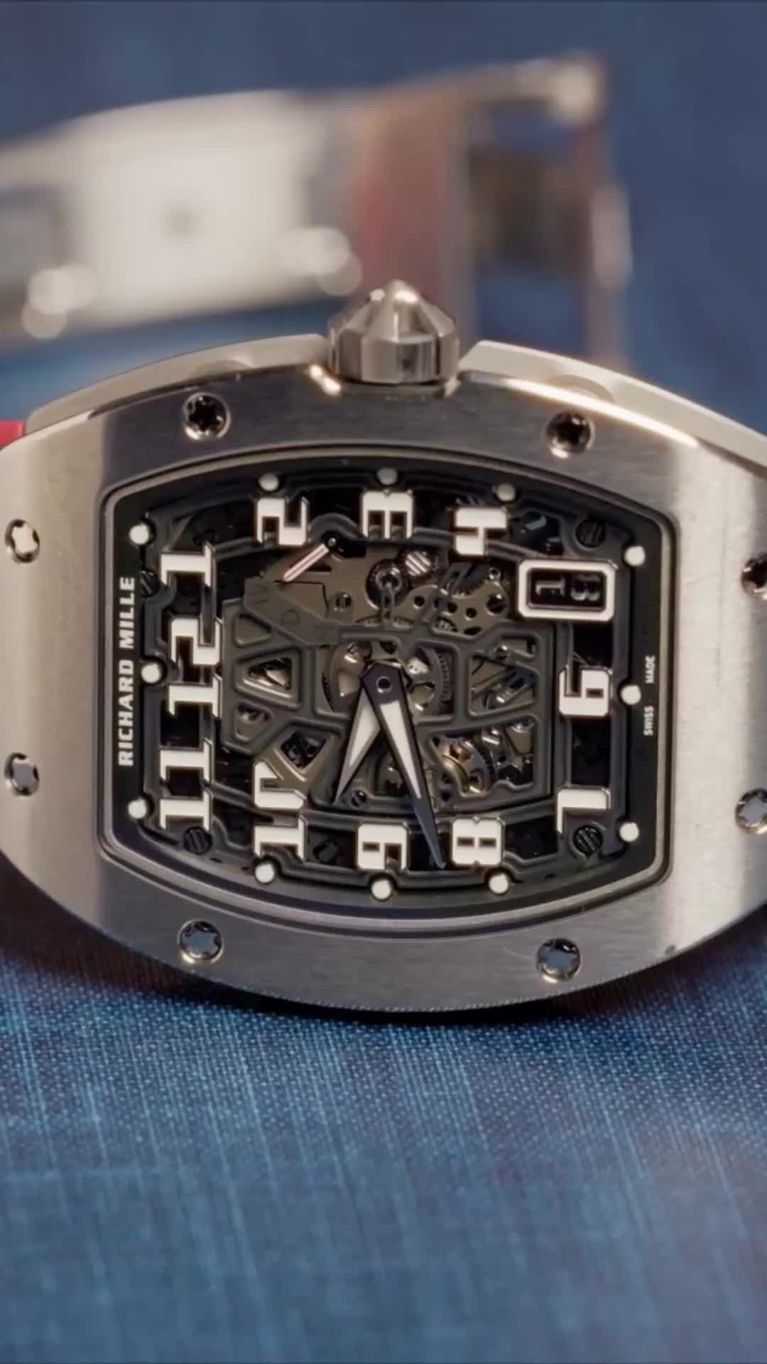 Richard Mille steals the show on TV. Until this, this thin profile, which they're having a very hard time making. This elegant titanium watch is definitely RM, it looks great on camera, it has a fantastic red band, and wardrobe approved it right away. After years of saying I need to wear an RM on the show they finally said yes. The Tonneau case shape has become extremely well known and recognizable. If you look from across the room, you can tell that that's an RM without seeing Richard Mille on the dial.