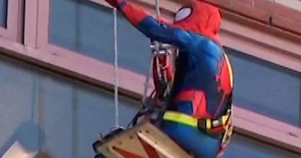 Window washers dress up as superheroes for kids