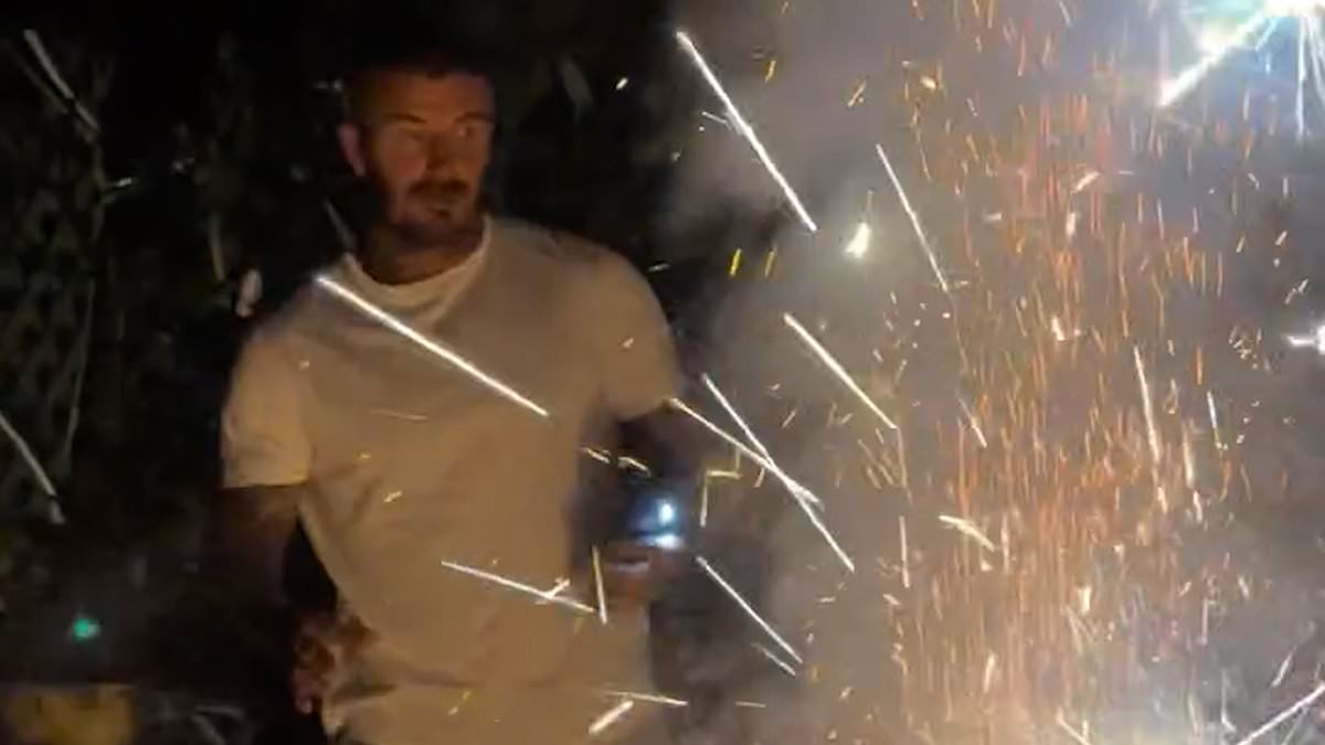 Sir David Beckham runs for cover as firework explodes in front of him