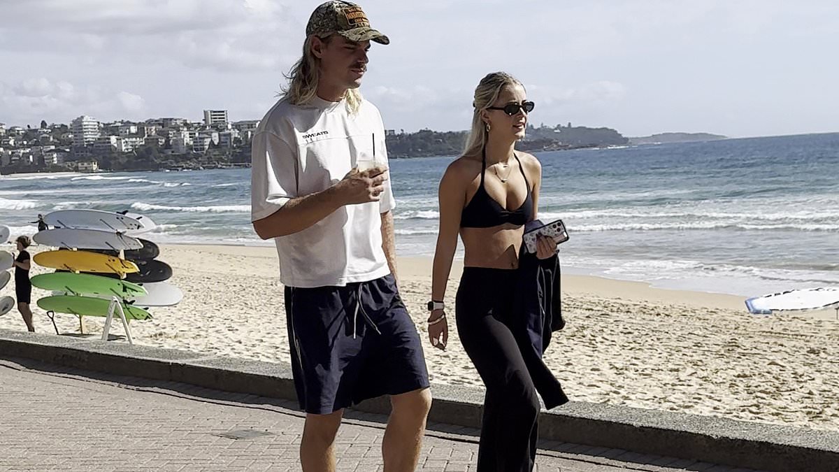 Tinder is paying off! AFL hunk Bailey Smith spotted on a romantic beach date with busty blonde Tammy Hembrow lookalike