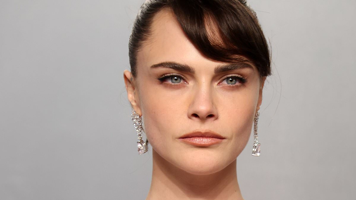 And the award for weirdest dress goes to…: Cara Delevingne steps out in a bizarre 'muscle dress' as she attends the Vanity Fair Oscars party