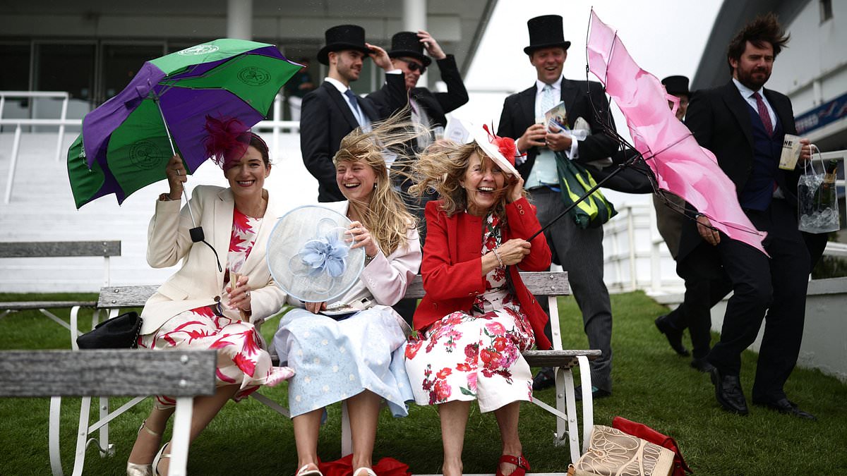 Epsom revellers shelter from the rain and wind as the clouds roll in on Derby day