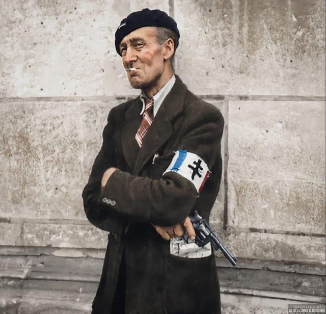 Member of the French Resistance and Veteran of the First World War, George Munch, photographed holding a handgun in Château de Beaumesnil, France, on the 30 August 1944. Munch was an Englishman who had married a French woman and settled down in France after World War I.