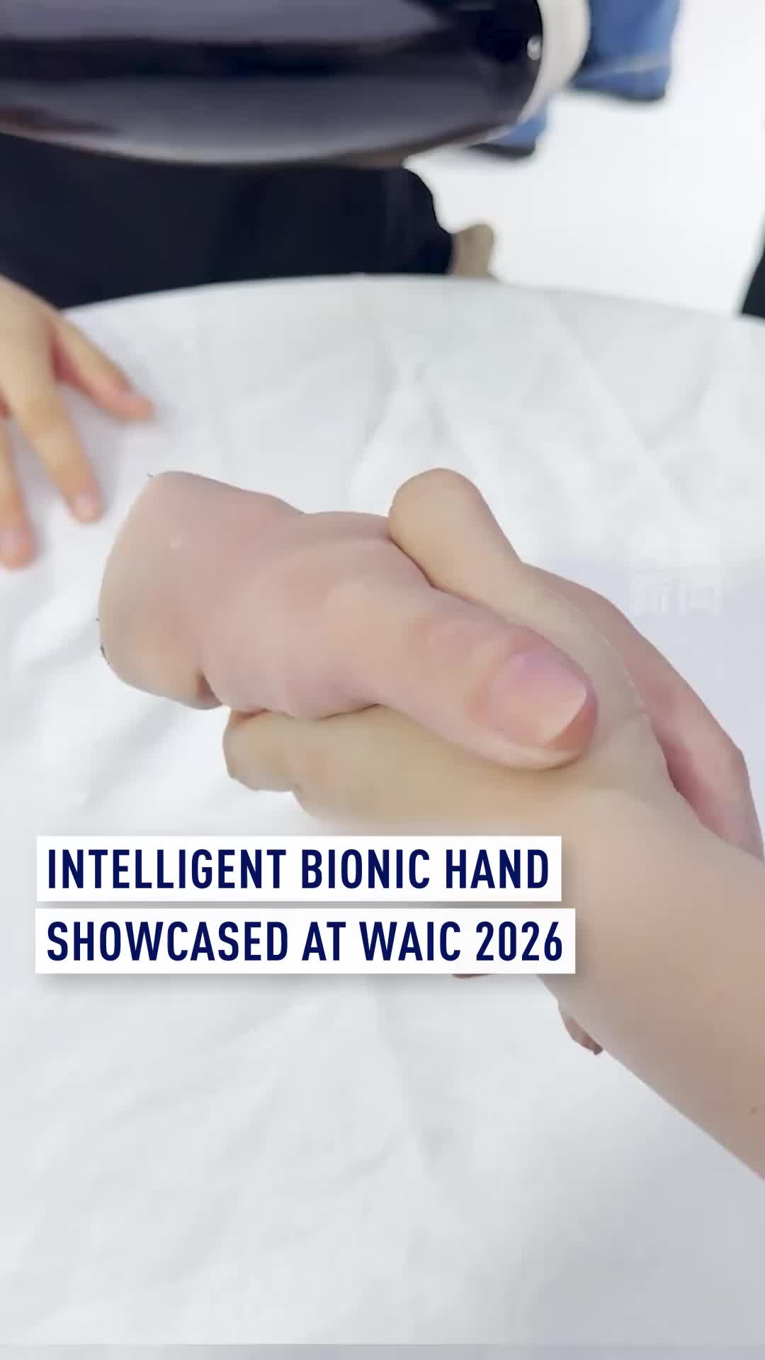 A Chinese company's smart bionic hand made its debut at the World Artificial Intelligence Conference (WAIC) in Shanghai, featuring hyper-realistic synthetic skin and seamless, fluid remote control. The AI-powered prosthetic can interpret nerve and muscle signals for intuitive movement, and can even operate independently. #WAIC2026 #AI #Robotics #BionicHand #Innovation #ChinaTech