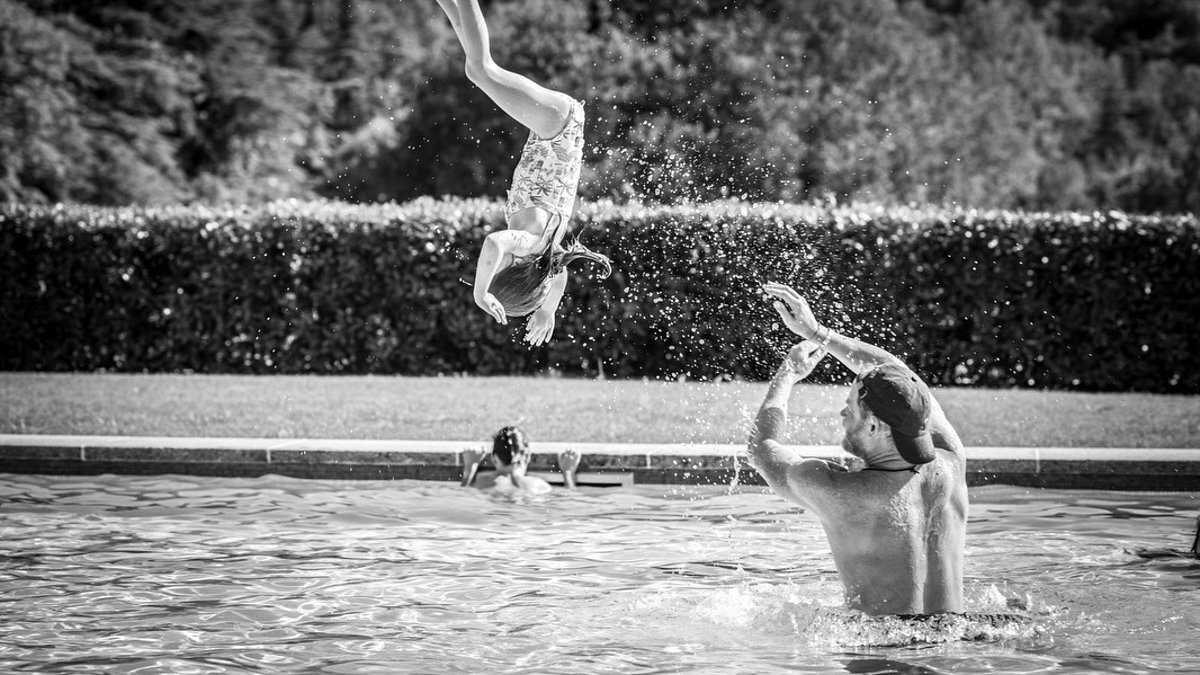 A royal water baby! How Lilibet has inherited Diana's love for swimming as young Princess frolics in the pool with Prince Harry in Meghan's European holiday snaps
