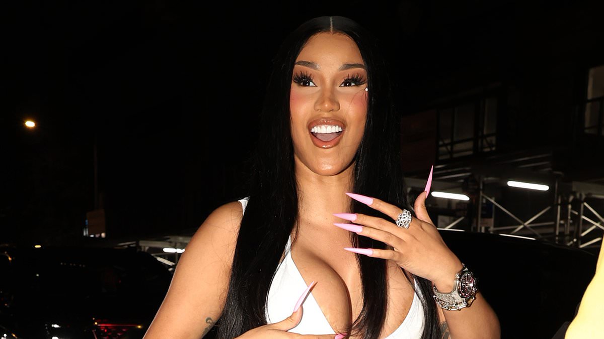 Cardi B turns heads in a plunging white top as she celebrates making history as the first female rapper to earn four diamond-certified songs