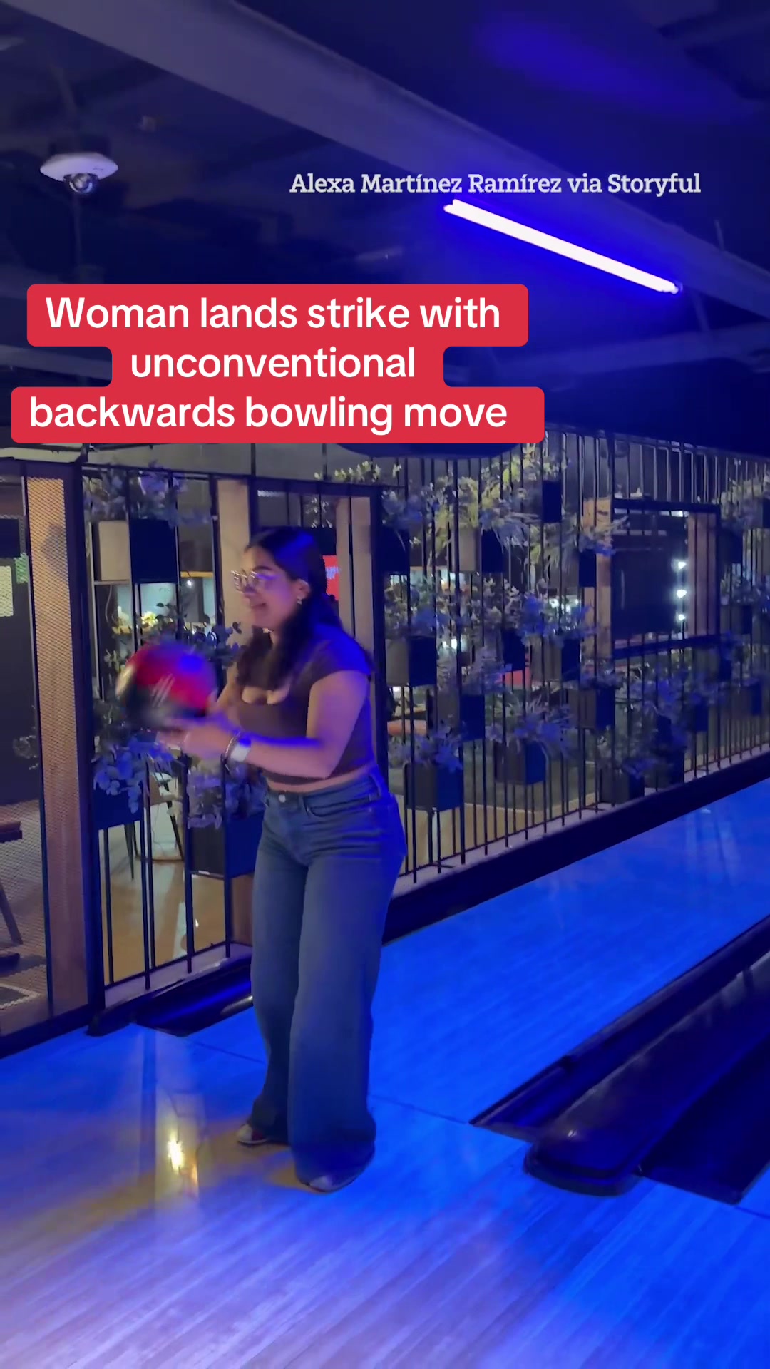 Watch the moment a woman lands a strike with an unconventional backwards bowling move. #Bowling #Technique #Skill #Strike